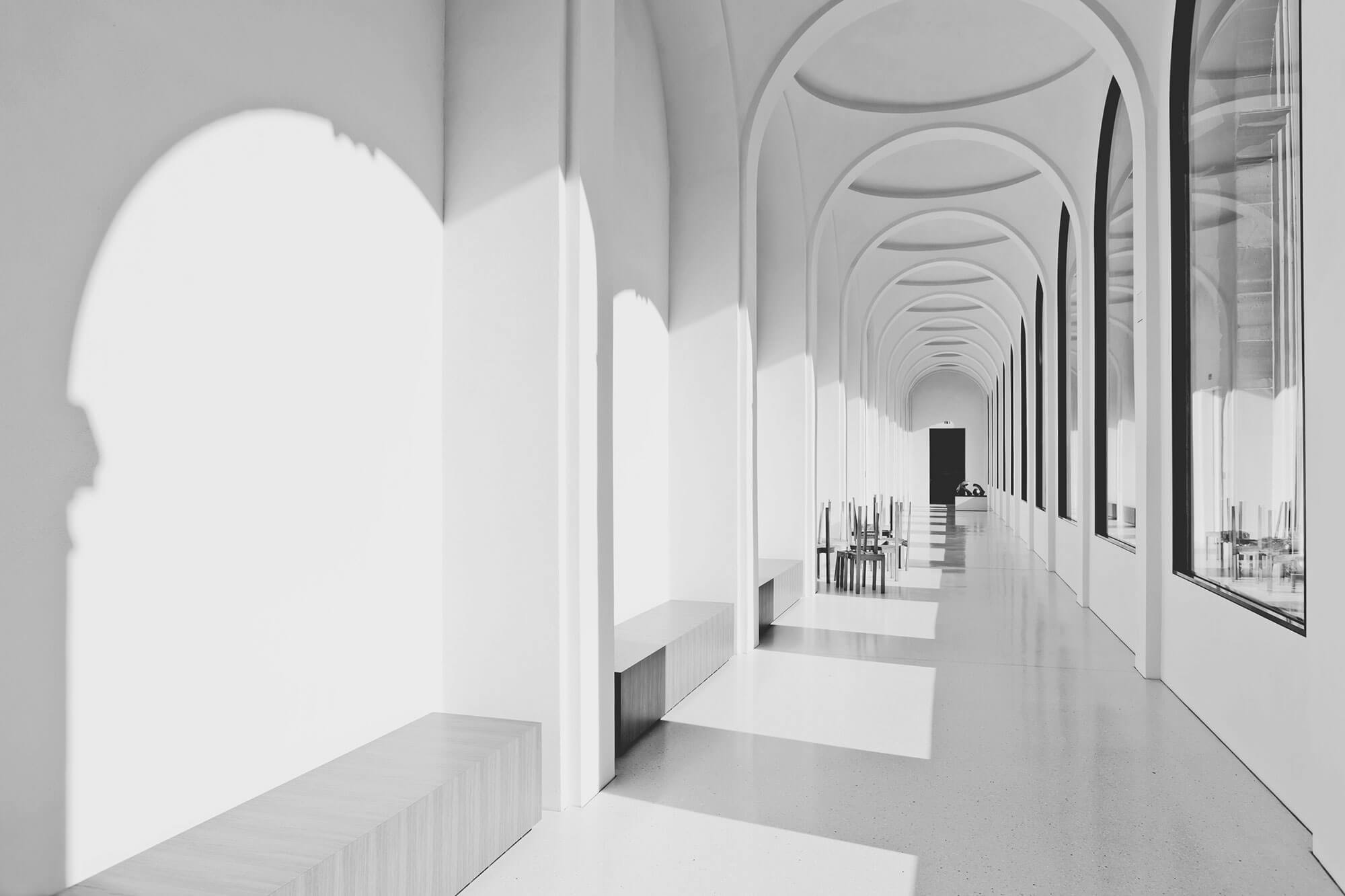 Gang mit Lichteinfall und Fenstern in Schwarz Weiss